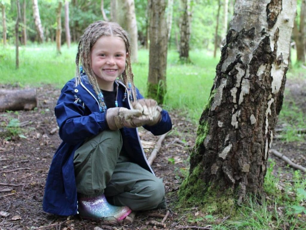 primary student by tree