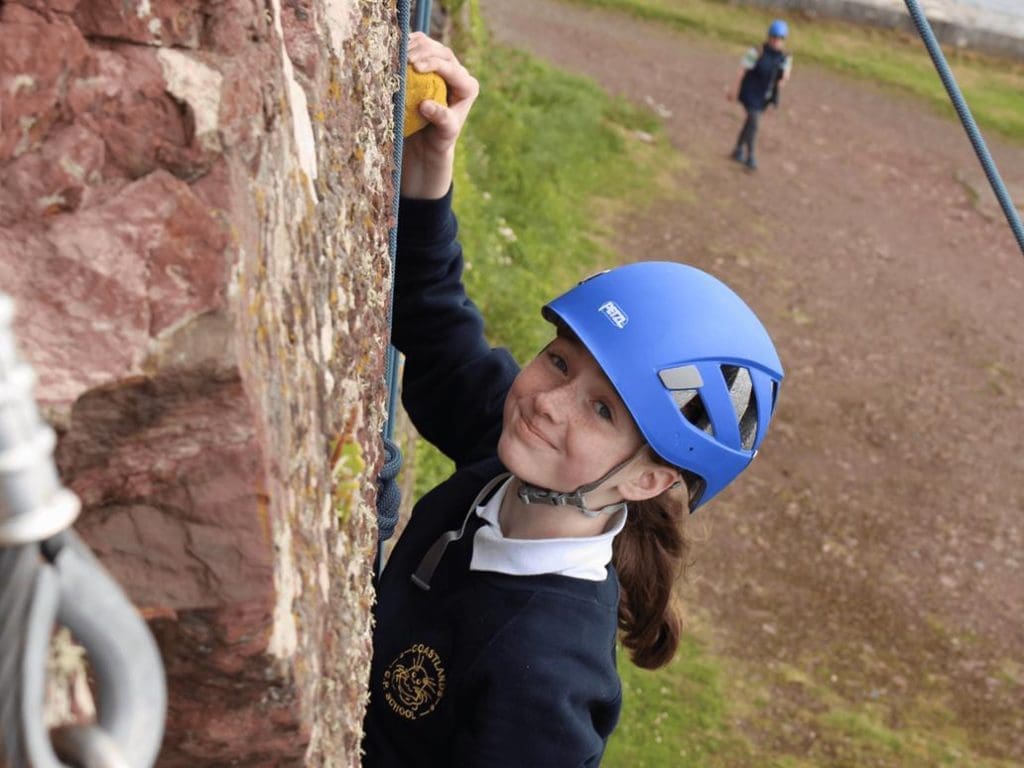 school trip pupil rock climbing