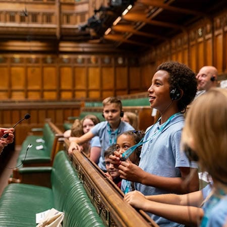 school pupils in a classroom at the houses of parliament in the chamber where MPs debate