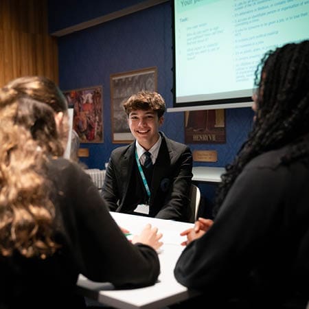 school pupils in a classroom at the houses of parliament on a school trip