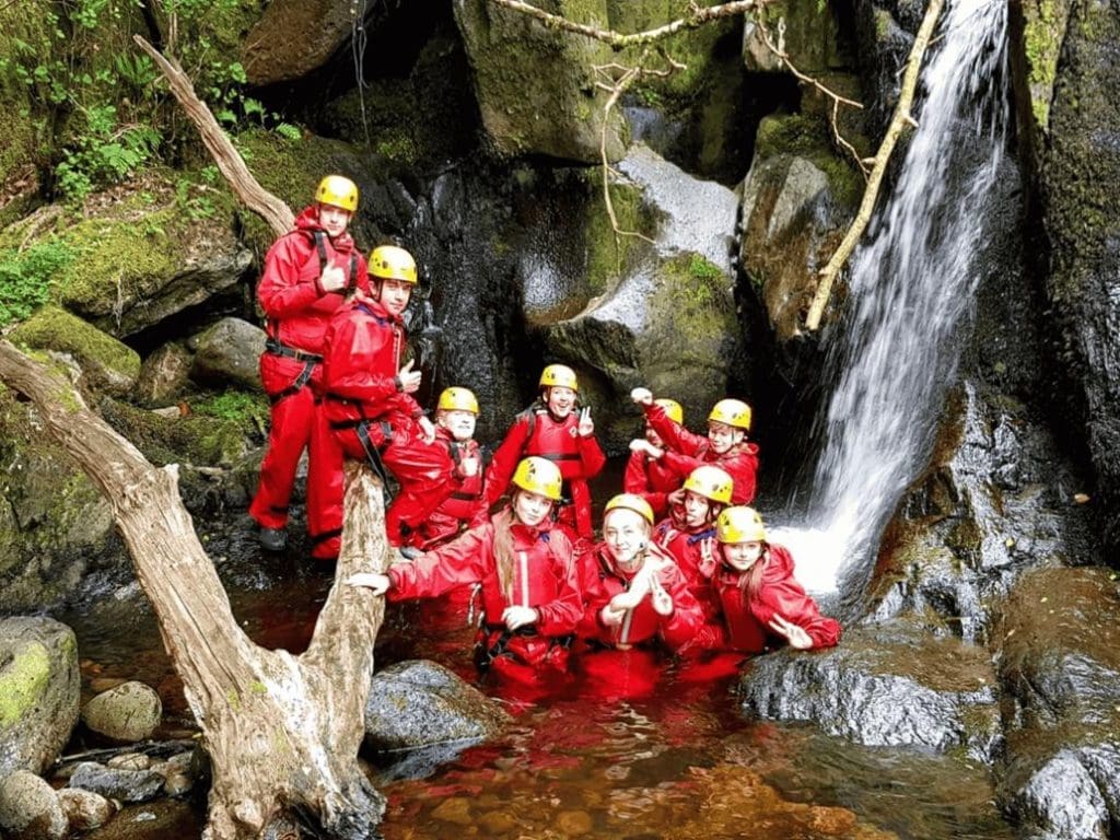 school trip group doing gorge climbing