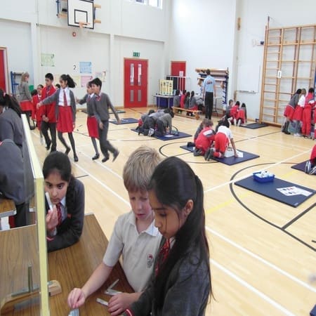 pupils working in the gym at health tasks at school with an outreach provider