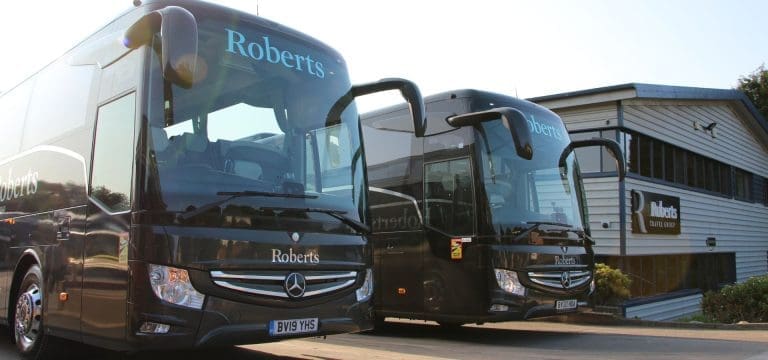 two coaches parked next to the head office building of Roberts travel group