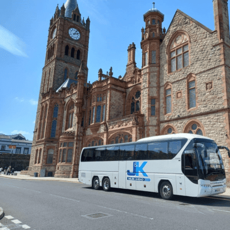 coach parked outside a historical building promoting coach hire