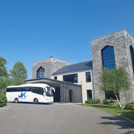 coach parked outside a church promoting coach hire services