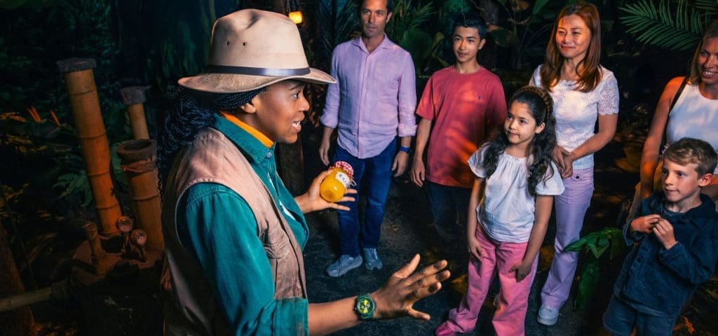 school trip tour with guide at the Paddington bear experience in forest clothing with tropical backdrop