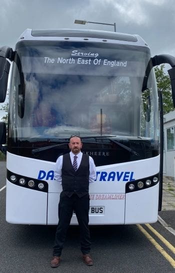 coach driver standing in front of coach