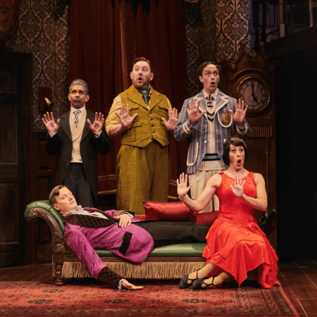 actors singing and waving on stage