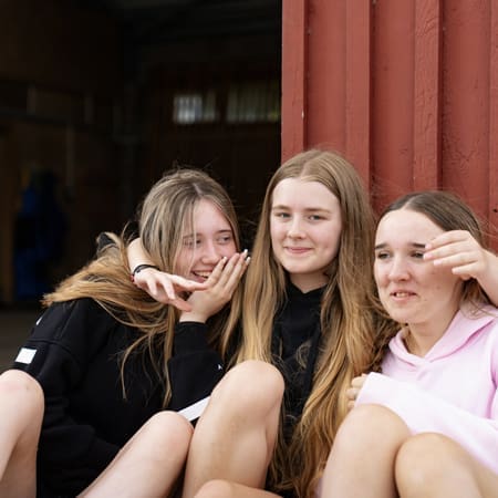 school pupils having a group photo smiling away on a school trip