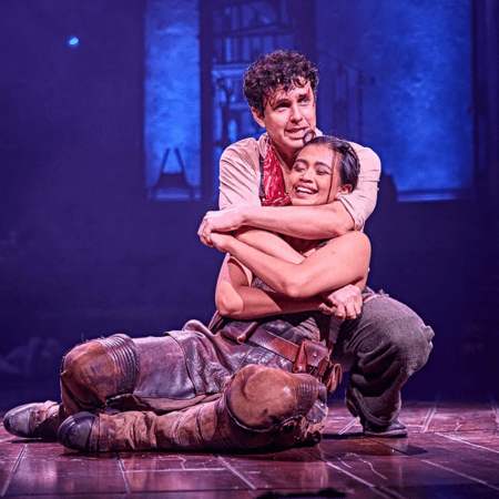 two actors in an embrace on stage at lyric theatre London