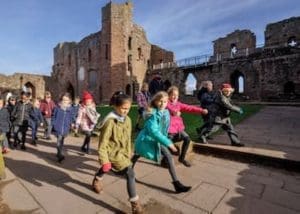 school group walking in grounds of a Norman Castle