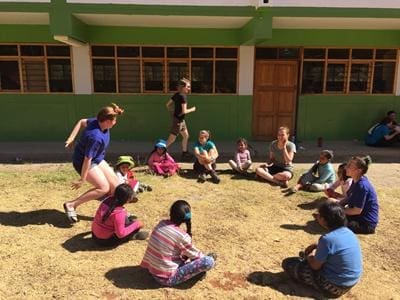 school group in a field playing games