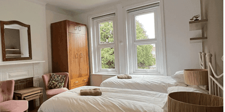 internal accommodation bedroom with two beds chairs and side tables