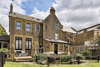 croft accommodation front of building set within gardens and iron railings