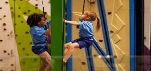school pupils at an indoor climbing activity centre doing climbing