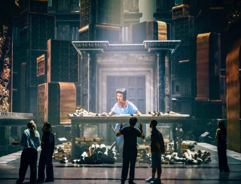 3D wall of Cleopatra with students looking on