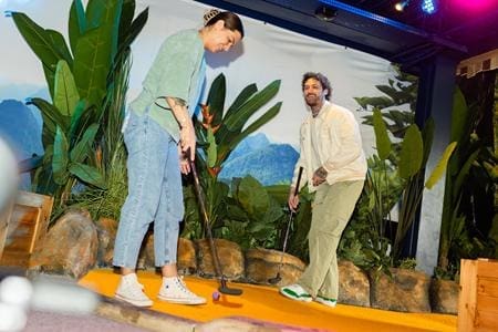 students playing indoor crazy golf