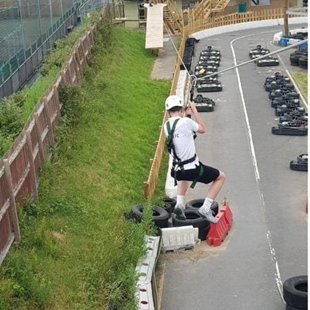 go karting track and student going down a zip line over it