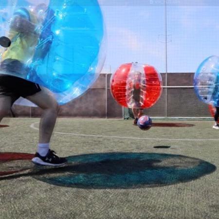 school pupils playing five aside football on astro pitch