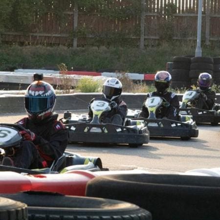 school pupils on a go karting track