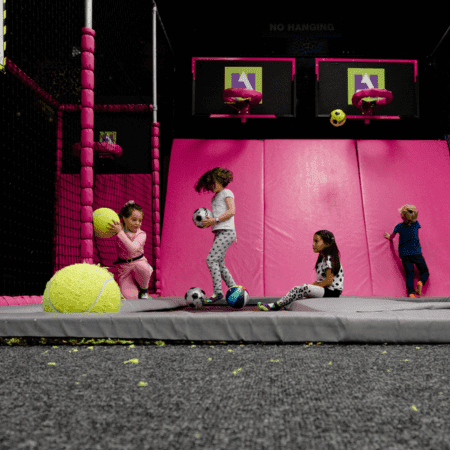 primary school group at an indoor play centre in a padded basket ball court